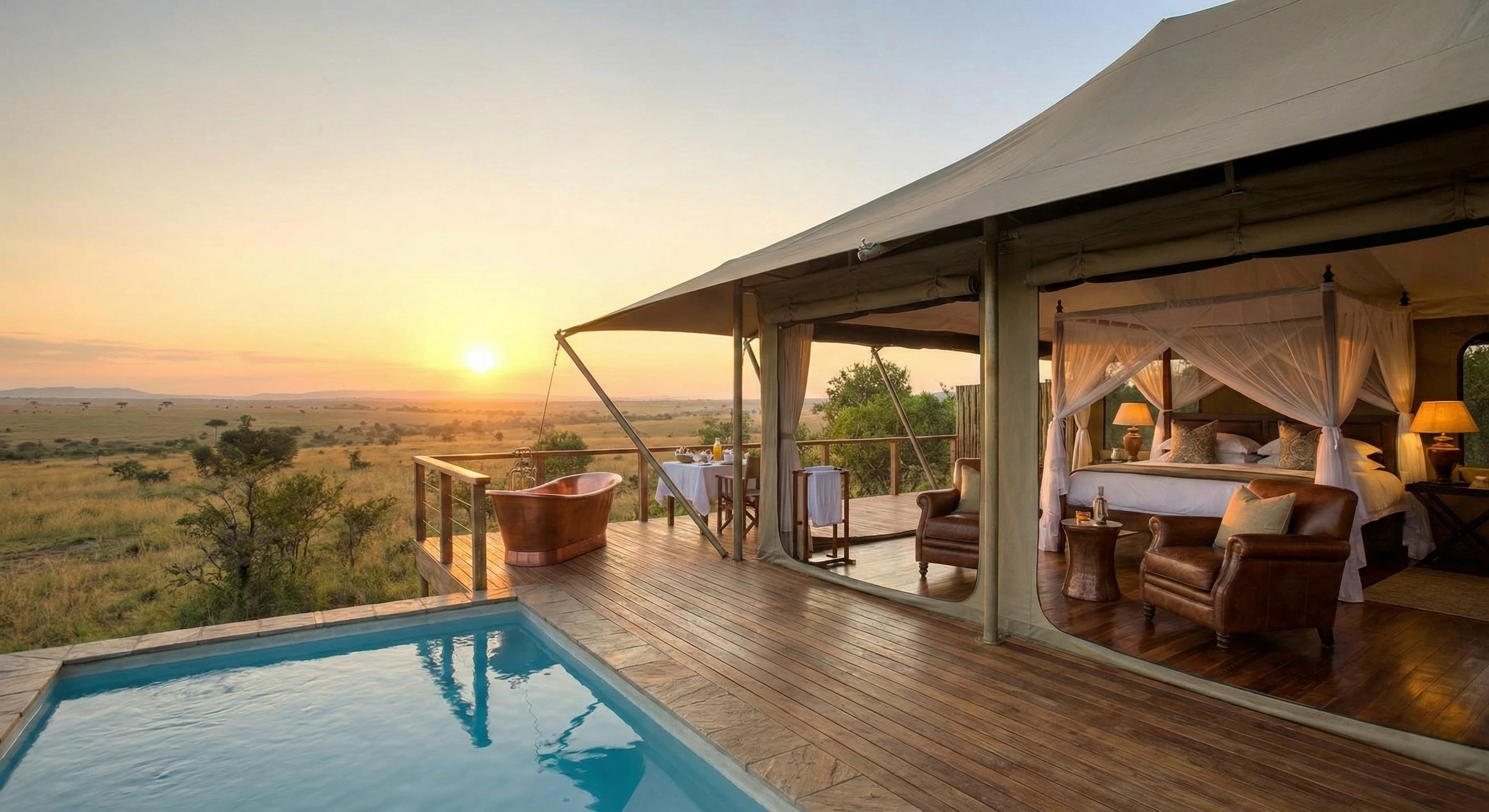 A magnificent luxury safari lodge terrace overlooking a golden savannah watering hole with lanterns lit for an evening dinner